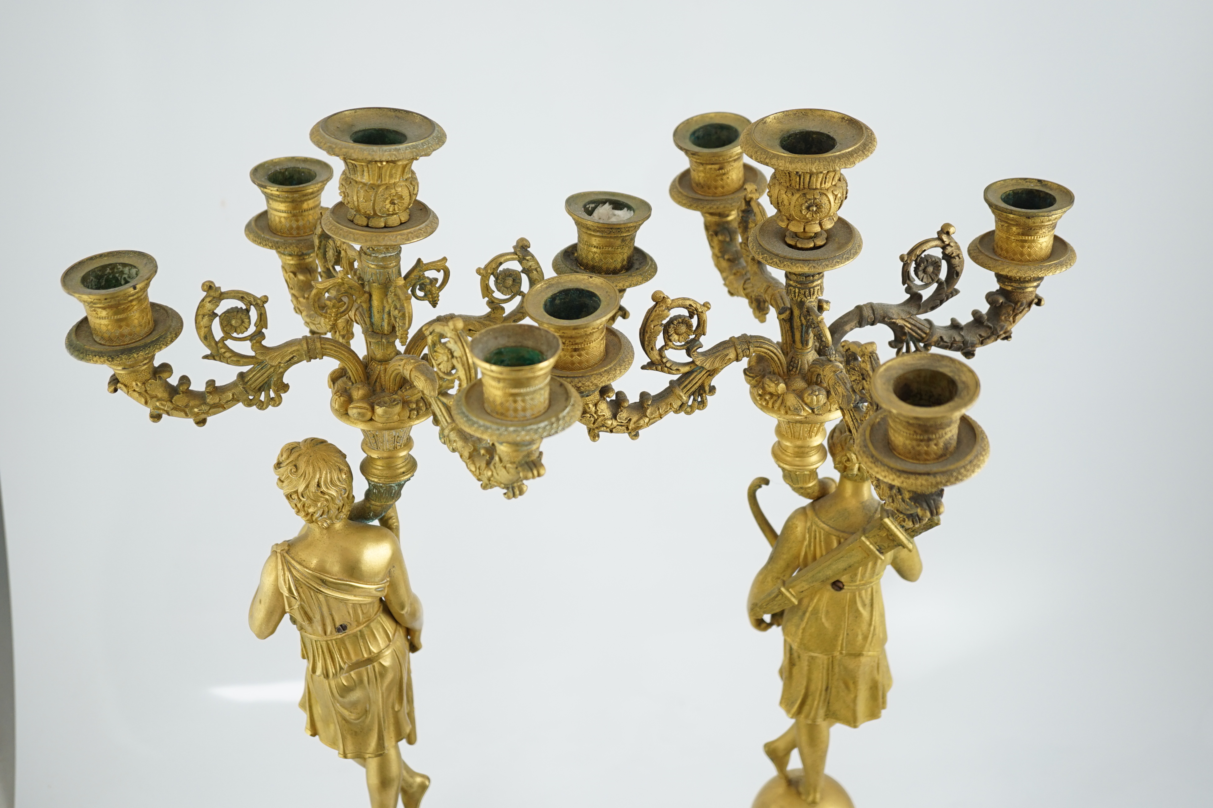 After Pierre-Philippe Thomire (1751-1843), a pair of Regency French Empire five light candelabra 25cm wide, 64cm high